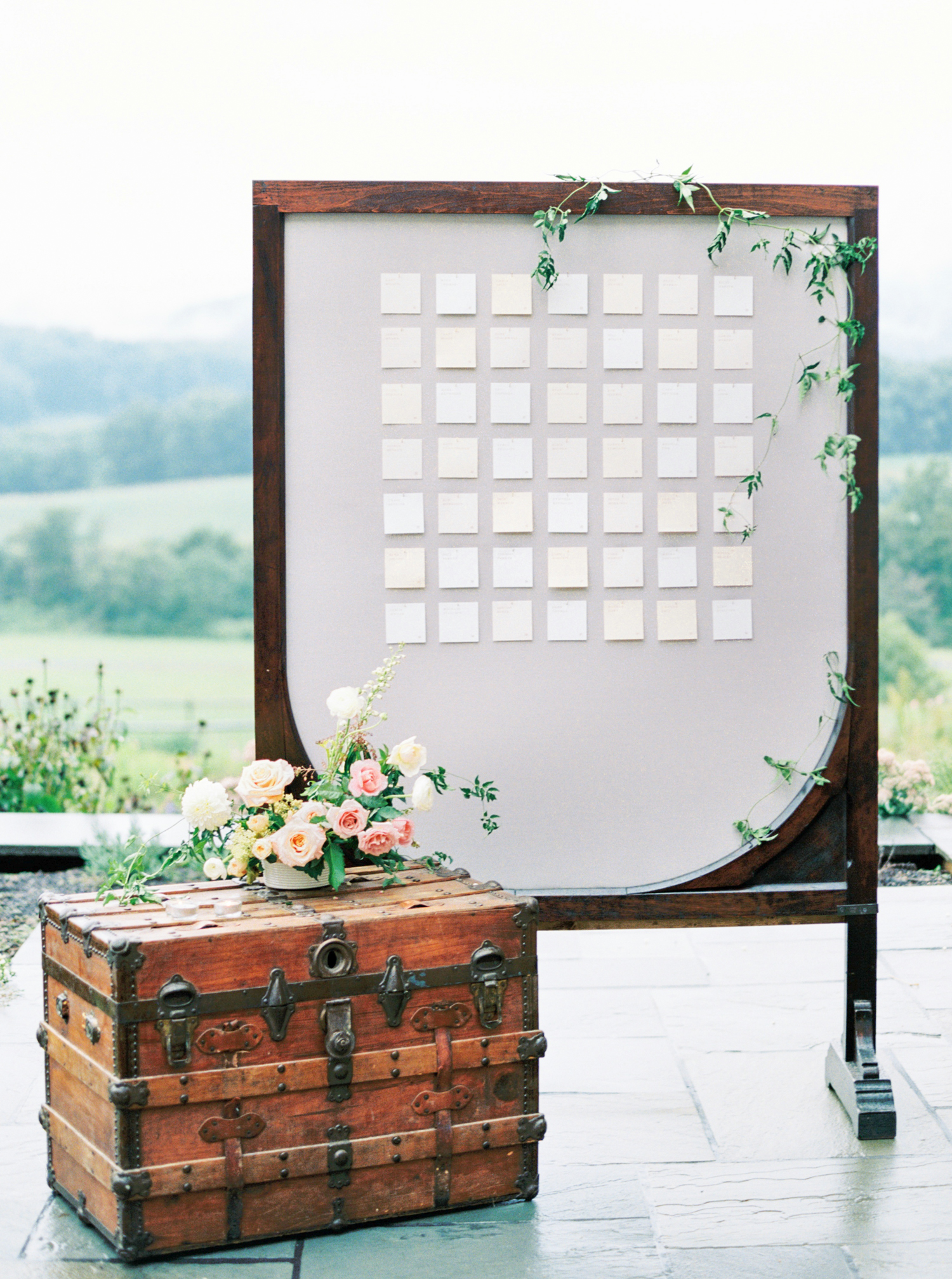 Pippin Hill Wedding Photos | Molly Carr Photography | Lauren Emerson Events | Pippin Hill Farm & Vineyard | Escort Card Display with Grey Backdrop and Greenery