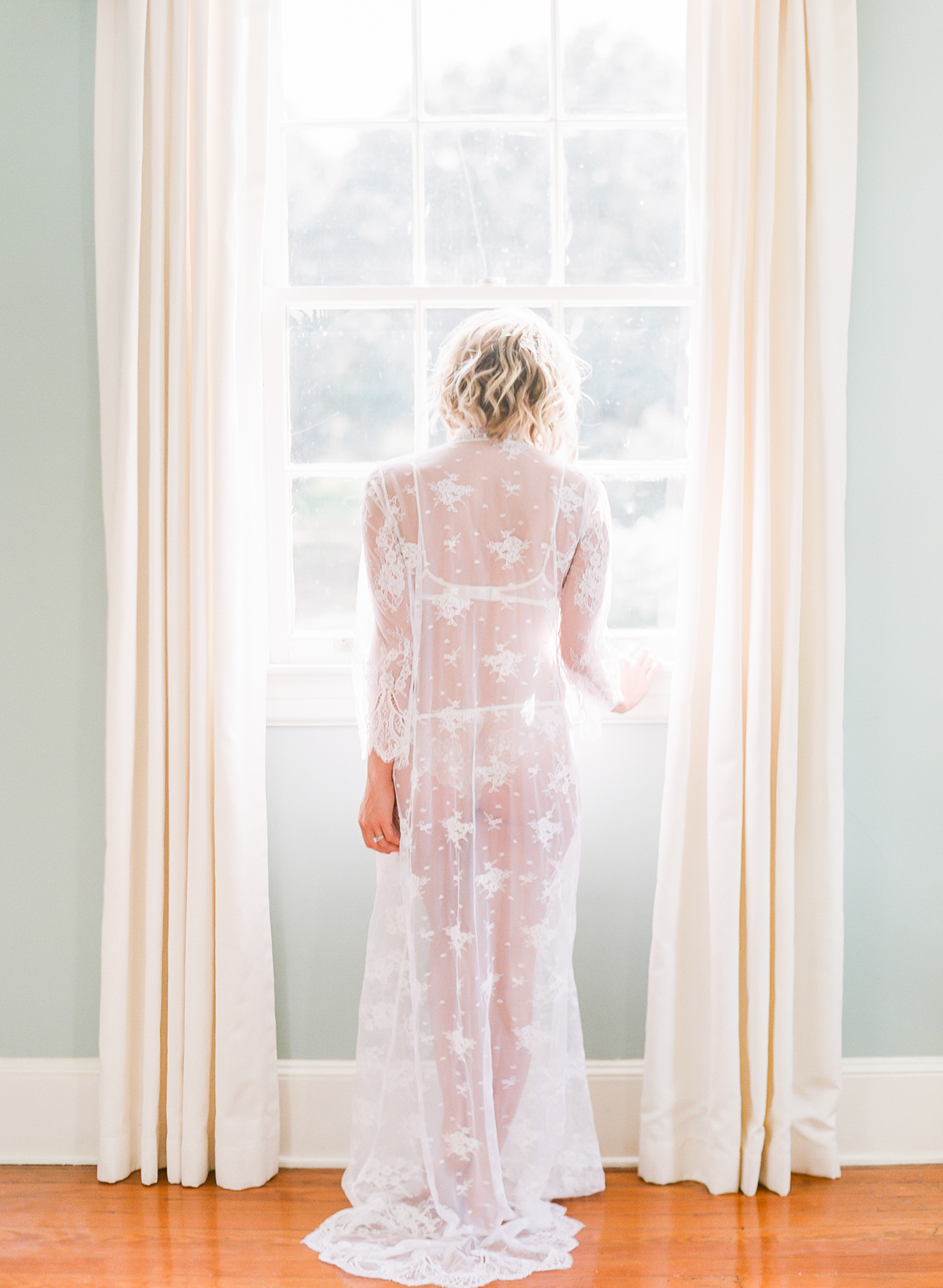 Legare Waring House Wedding Photography | Charleston Wedding Photographer | Charleston Film Photographer | Molly Carr Photography | The Petal Report | Emily Kotarski Bridal | Charleston Boudoir Photography | Illford 3200 Film | Bridal boudoir with veil and crown | The Lace Atelier | Bride Standing by Window with Floor Length Lace Robe