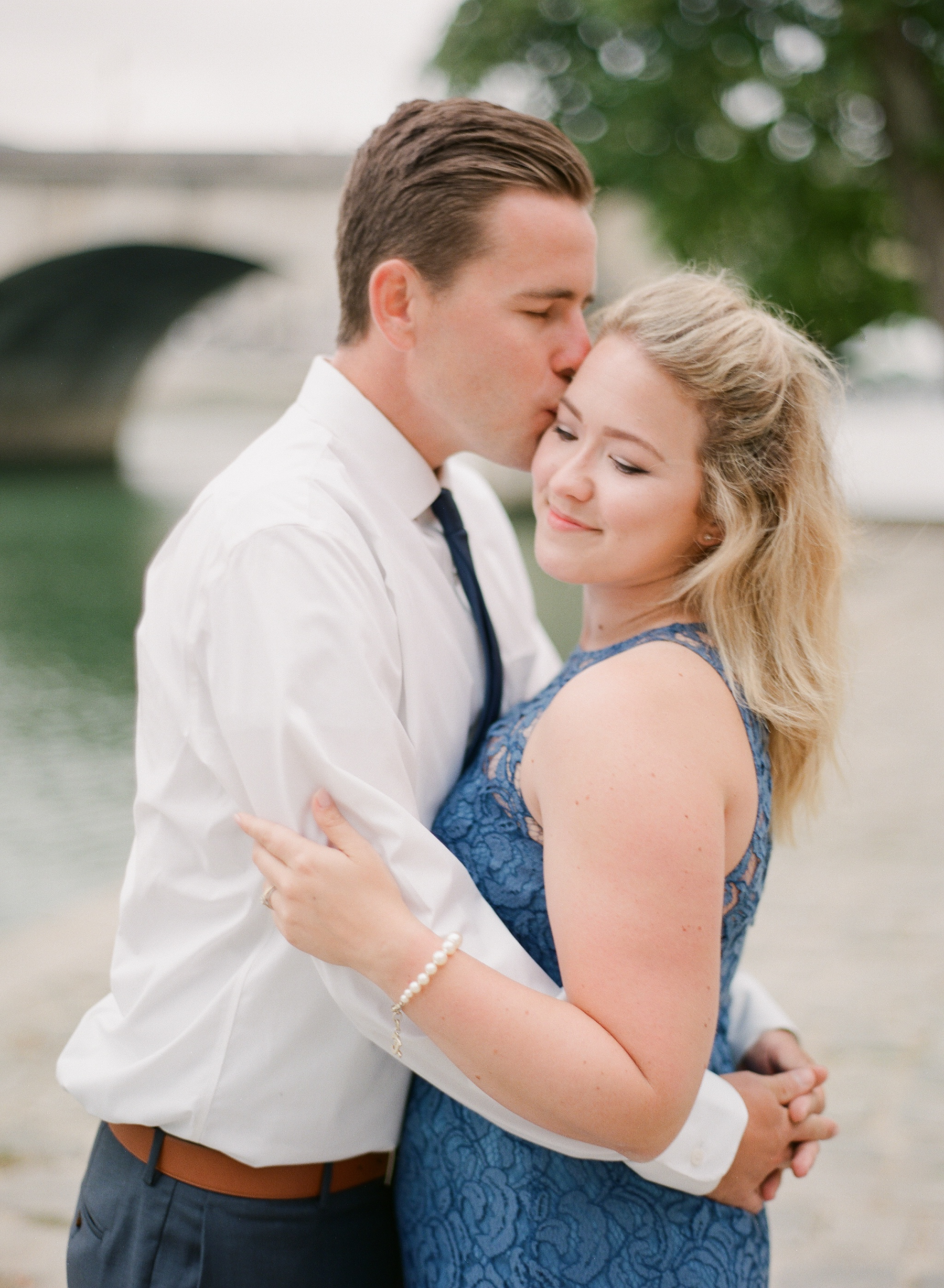 Paris Honeymoon Photographer | France Wedding Photographer | Paris Film Photography | Molly Carr Photography | Bride And Groom Kissing At The Seine | Girl In Blue Lace JCrew Dress