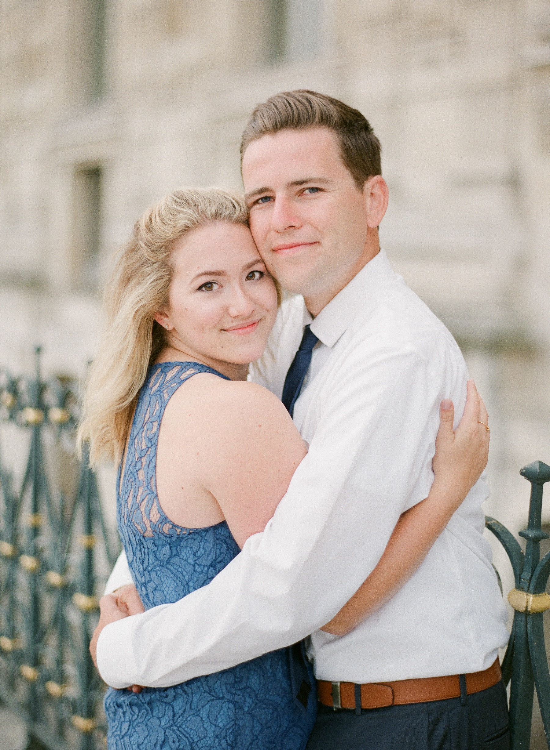 Paris Honeymoon Photographer | France Wedding Photographer | Paris Film Photography | Molly Carr Photography | Engagement Session At The Louvre | Bride And Groom Hugging | Girl In Blue Lace JCrew Dress