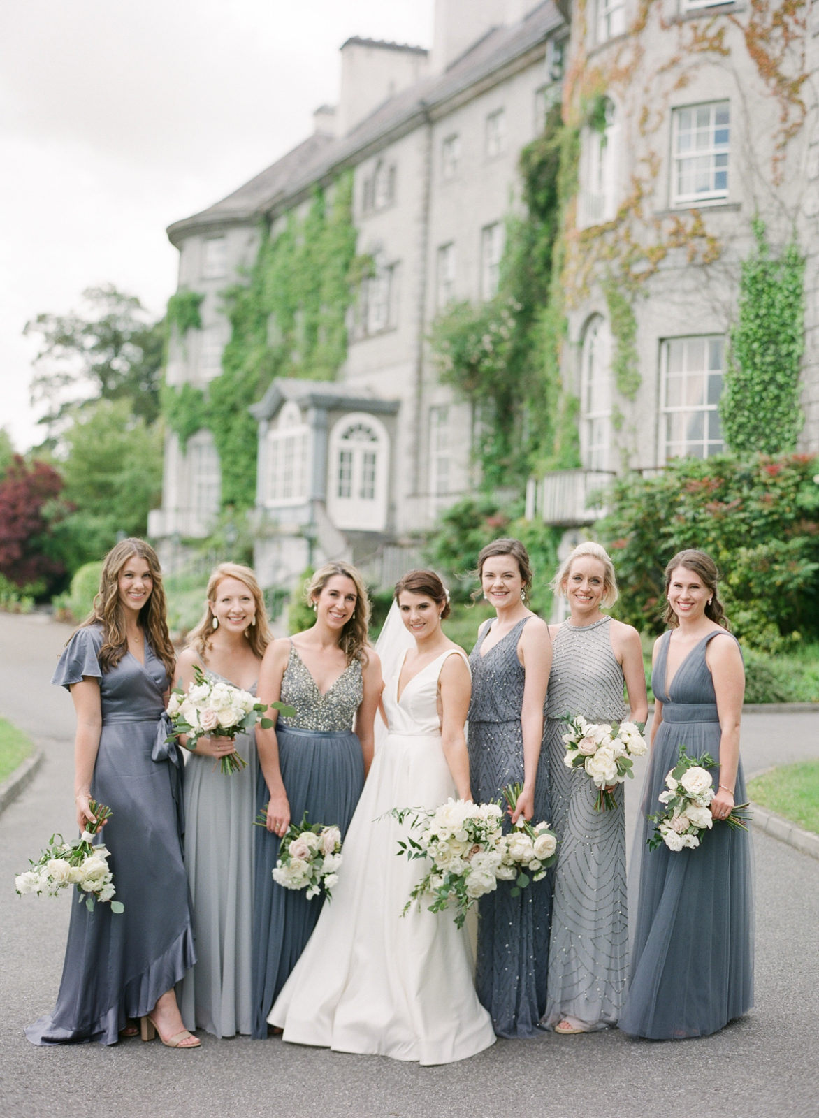 Ireland Film Photographer | Molly Carr Photography | Bride in White Jenny Yoo Dress and Bridesmaids in Grey Mismatched Bhldn Gowns with White Bridal Bouquets at Mount Juliet Estate