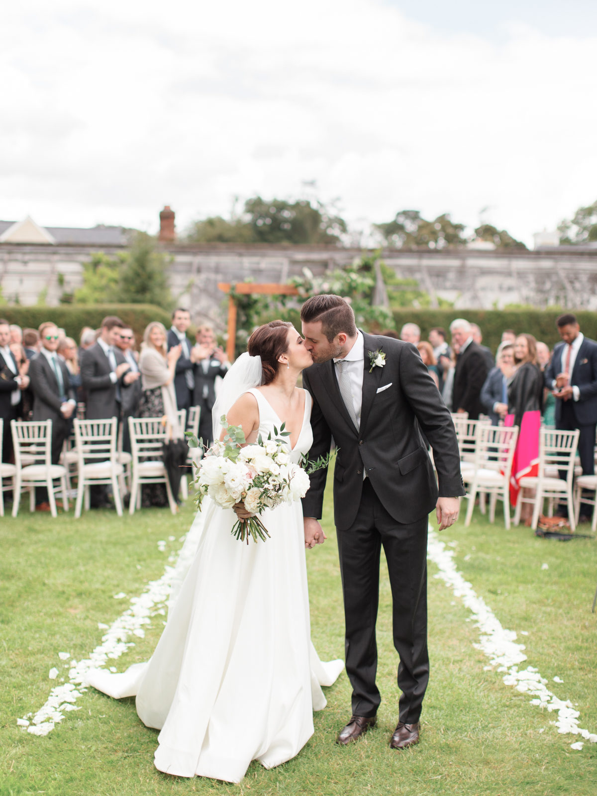 Ireland Film Photographer | Molly Carr Photography | Bride and Groom Kissing During Mount Juliet Estate Garden Wedding Ceremony
