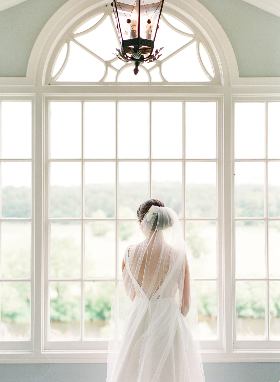 Ireland Film Photographer | Molly Carr Photography | Mount Juliet Estate Wedding with Bride in Jenny Yoo Dress and Veil Looking Out the Window