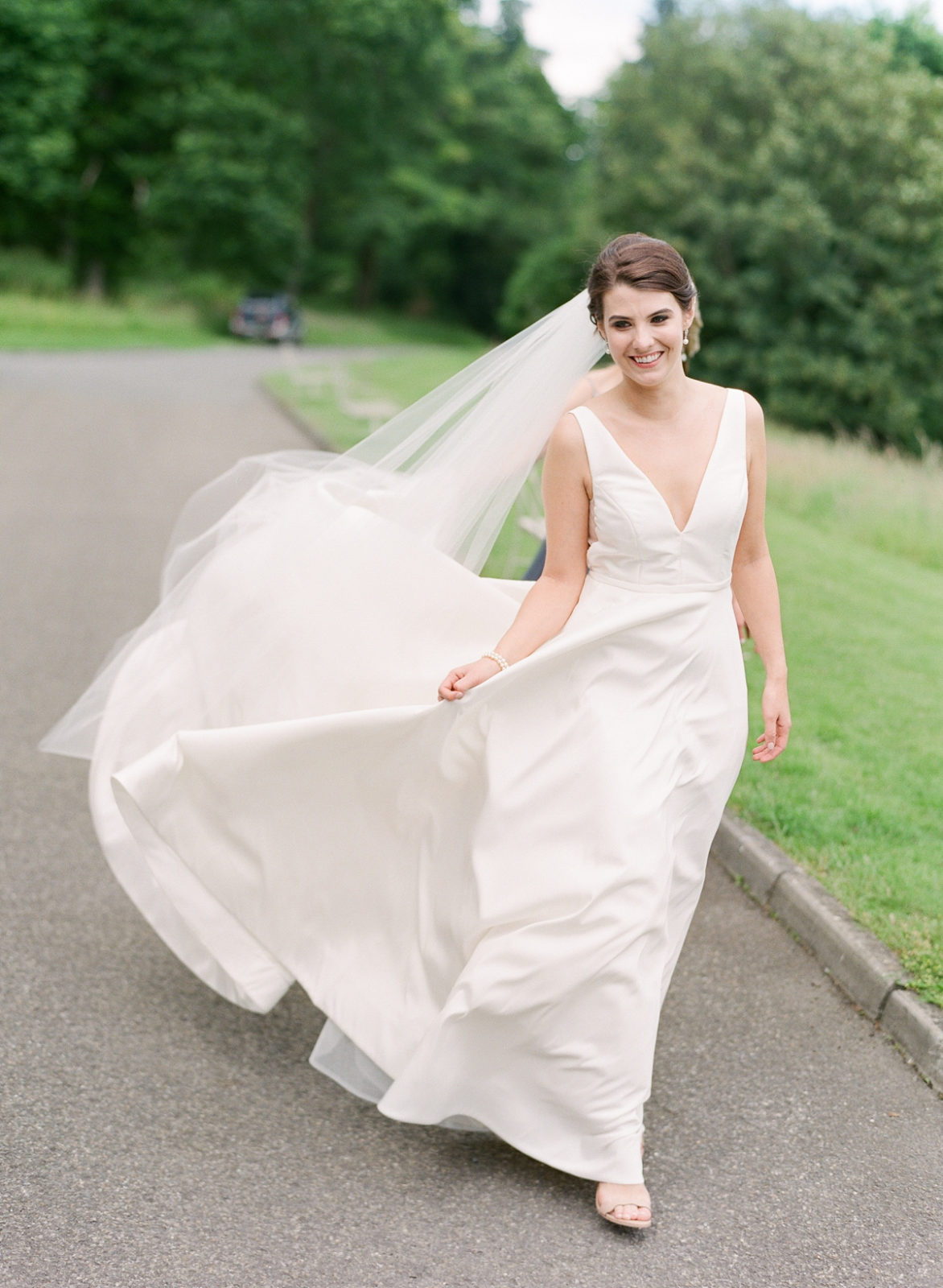 Ireland Film Photographer | Molly Carr Photography | Bride Walking in White Jenny Yoo Wedding Dress Blowing in the Wind