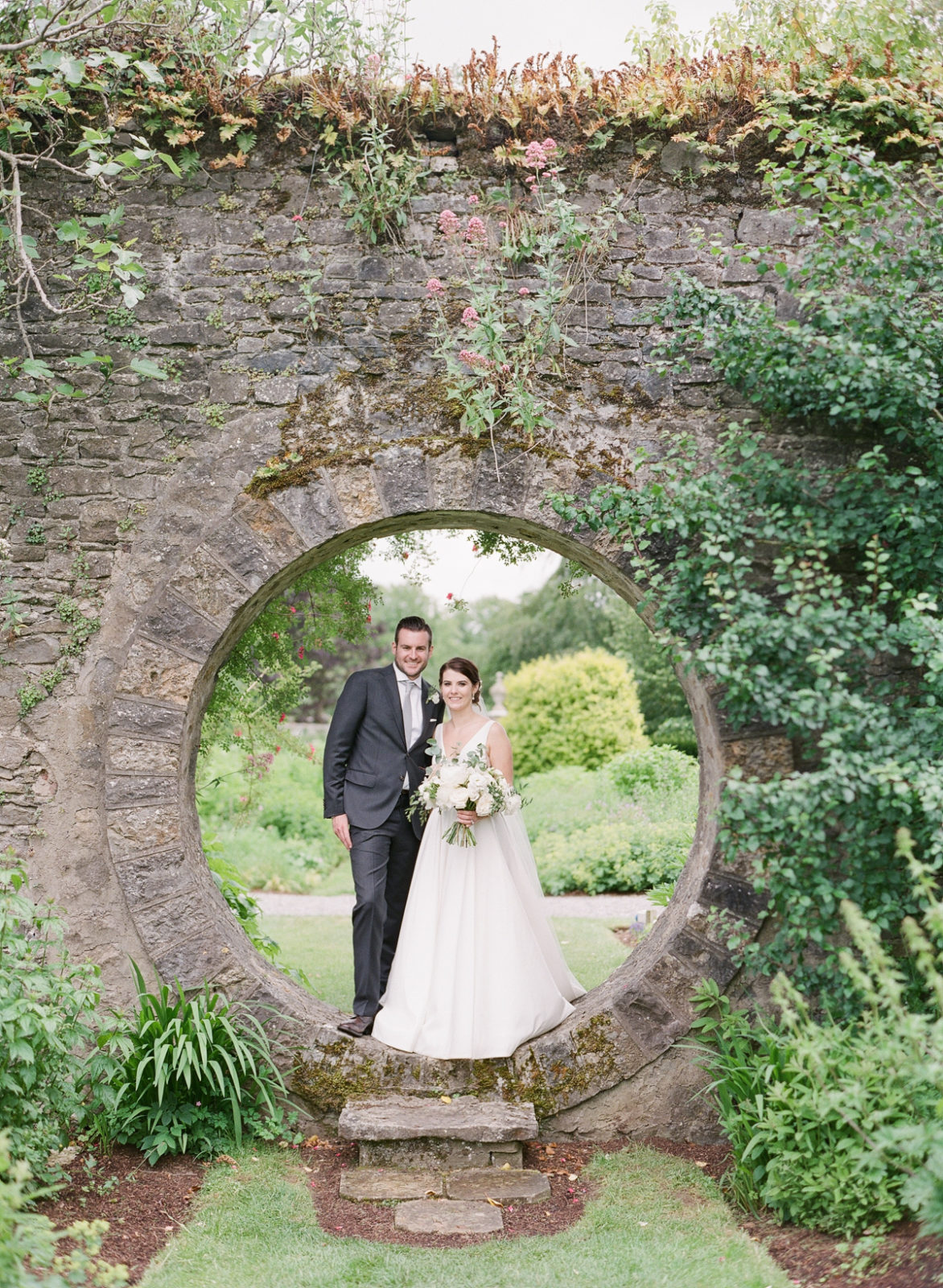 Ireland Film Photographer | Molly Carr Photography | Bride in White Jenny Yoo Wedding Dress and Groom in Grey Suit in Mount Juliet Estate Moon Garden