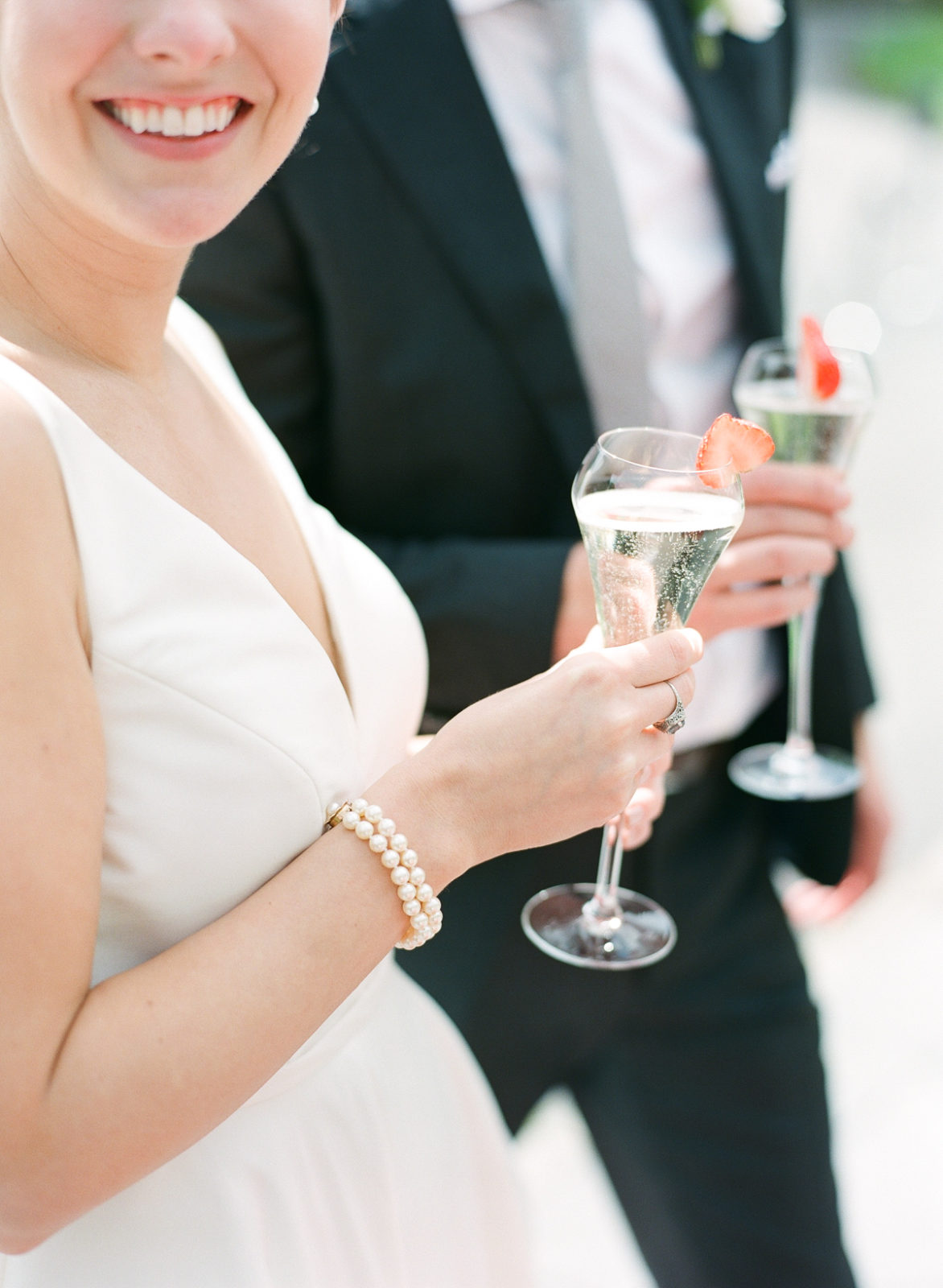 Ireland Film Photographer | Molly Carr Photography | Bride in White Jenny Yoo Wedding Gown and Pearls Toasting Champagne