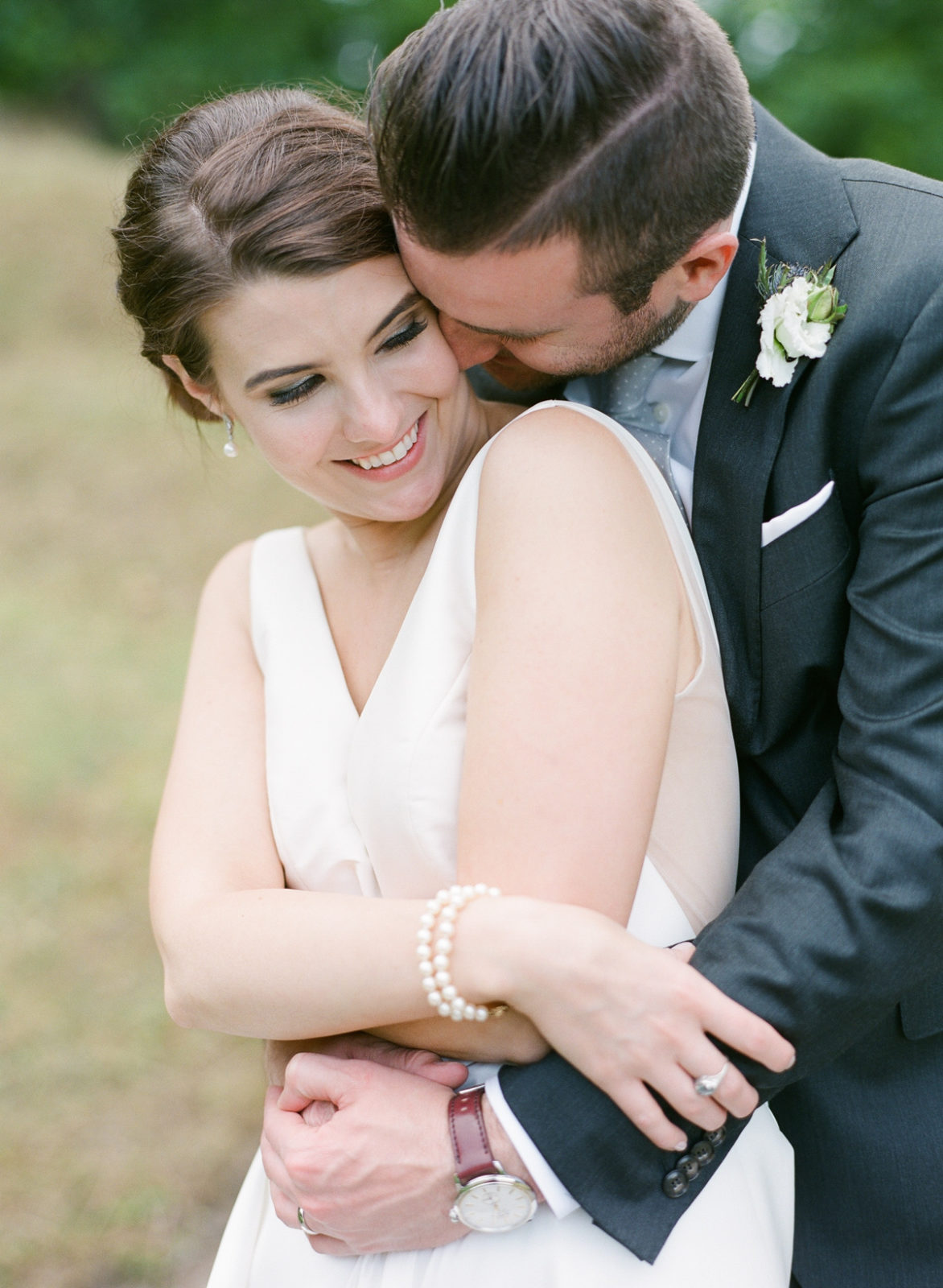 Ireland Film Photographer | Molly Carr Photography | Bride in White Jenny Yoo Dress and Groom in Grey Suit Kissing