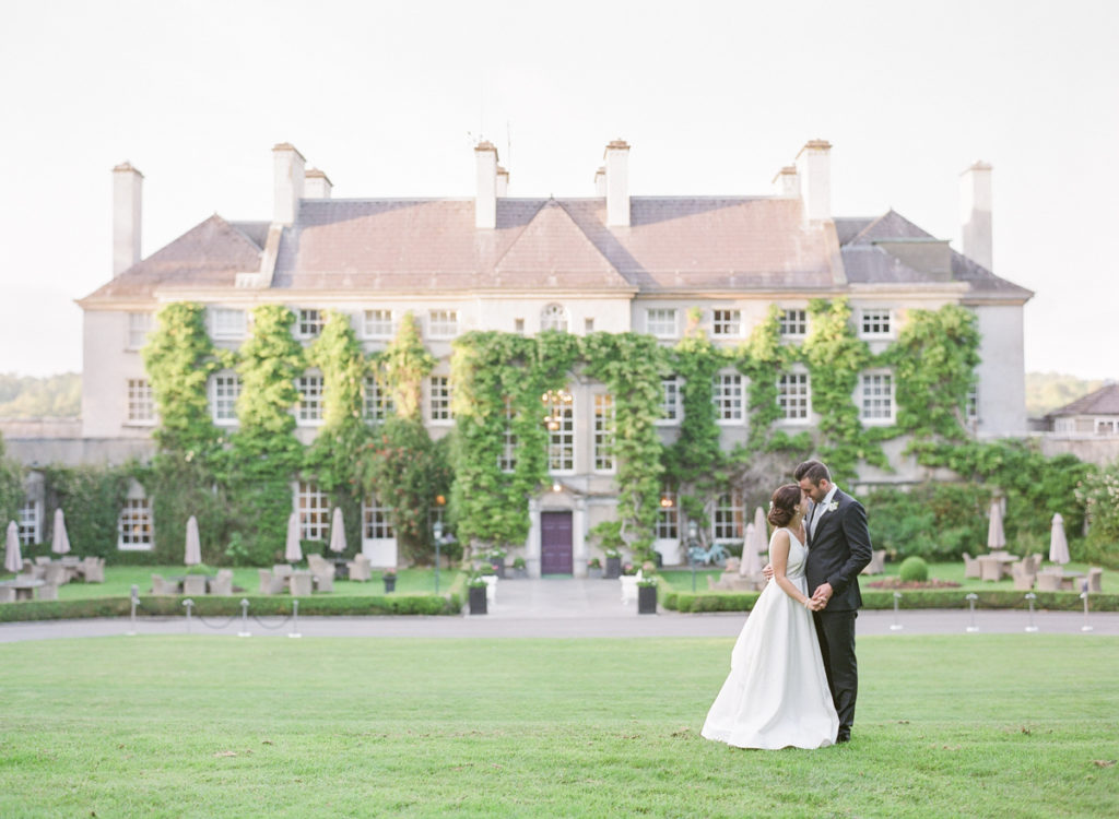Ireland Film Photographer | Molly Carr Photography | Mount Juliet Estate Lady Helen Dining Room Wedding Reception with White Wedding Flowers and CandlesIreland Film Photographer | Molly Carr Photography | Mount Juliet Estate Wedding with Bride and Groom Kissing in Front of Irish Manor House