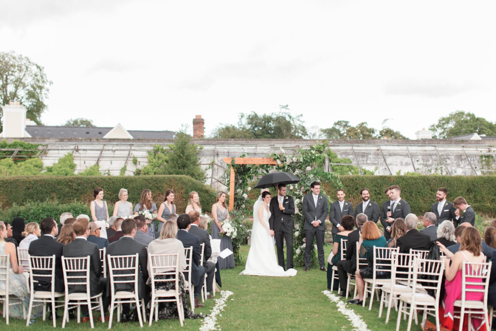 Ireland Film Photographer | Molly Carr Photography | Bride and Groom Under Black Umbrellas During Mount Juliet Estate Wedding Ceremony